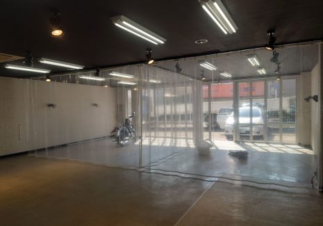 カーコーティング会社の作業スペースの区画分けのために糸入り透明ビニールカーテンを設置