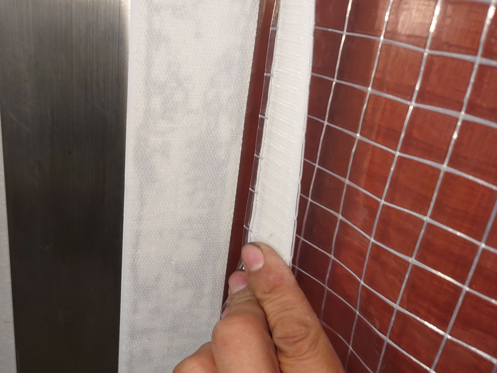 ビニールカーテン両サイドは壁面に隙間なく固定できるよう糊付きマジックテープを使用